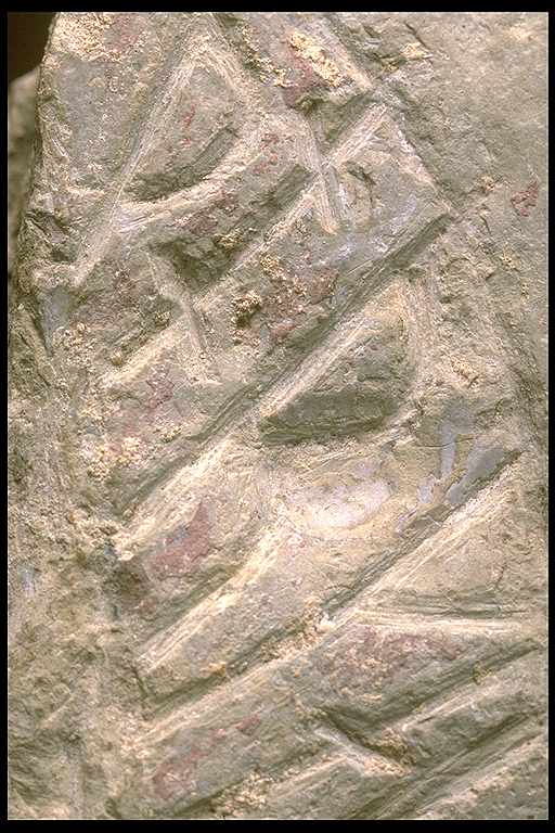 Runes written on fragment av runsten, grå kalksten. Date: V
